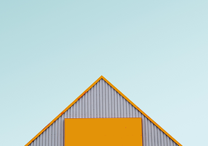 big white arrow on a blue wall